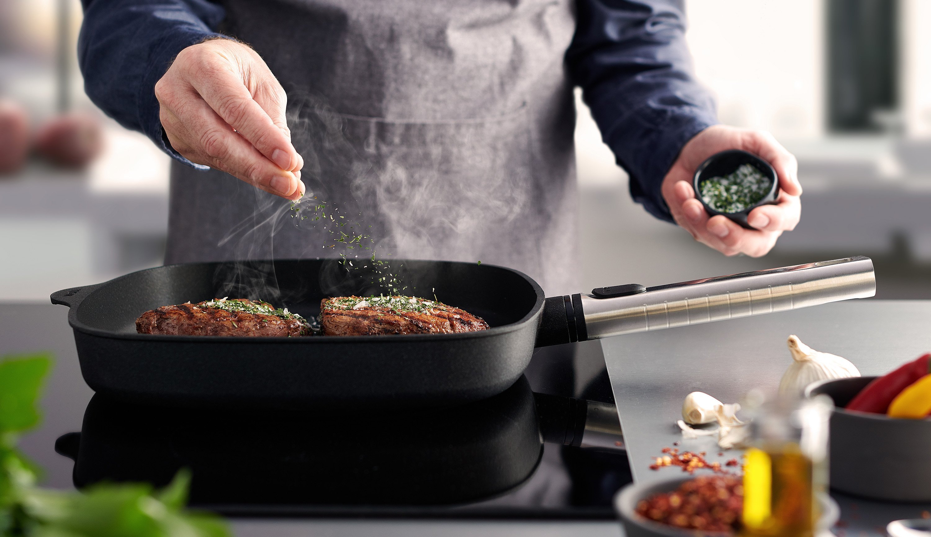 In einer runden Logic XR Pfanne wird Fleisch angebraten und mit Salz verfeinert. 